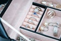 Jewelry box with white gold and silver rings, earrings and pendants with pearls. Collection of luxury jewelry. Royalty Free Stock Photo