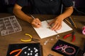 Jewelry designer works on a hand drawing sketch Royalty Free Stock Photo