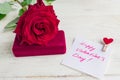 Jewelry gift box and bautiful red rose on wooden background. Present for Valentine`s day Royalty Free Stock Photo