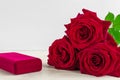 Jewelry gift box and bautiful red roses on wooden background Royalty Free Stock Photo