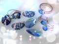 Jewelry gold silver blue stone rings earrings green emerald ,blue crystal gems, rings, necklace close up shot , on white b