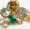 Jewelry green emerald white pearl and yellow citrine gold rings pink on white background