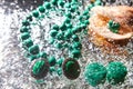 Jewelry from green malachite. Malachite beads in the studio on a glass surface with water Royalty Free Stock Photo