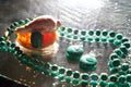 Jewelry from green malachite. Malachite beads in the studio on a glass surface with water Royalty Free Stock Photo