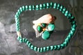 Jewelry from green malachite. Malachite beads in the studio on a glass surface with water Royalty Free Stock Photo