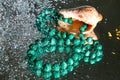 Jewelry from green malachite. Malachite beads in the studio on a glass surface with water Royalty Free Stock Photo