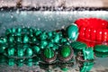 Jewelry from green malachite. Malachite beads in the studio on a glass surface with water Royalty Free Stock Photo