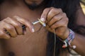 Jewelry maker hands creating earrings from metal string