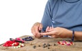 Jewelry making. Making bracelet from multi-colored beads on a rough wooden