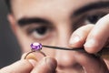Jewelry master examines the gold ring for defects