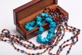 Jewelry old box and blue bead necklace. Isolated on a white background. Royalty Free Stock Photo