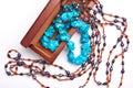 Jewelry old box and blue bead necklace. Isolated on a white background. Royalty Free Stock Photo