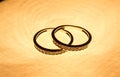 Jewelry photography. Three gold rings on gradient reflective surface. Background.