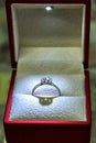 Jewelry production. White gold diamond ring in ice-lit gift box. Wedding, engagement, marriage proposal