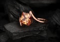 Jewelry ring with big topaz gem on black coal background Royalty Free Stock Photo