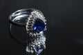 jewelry ring witht big blue sapphir on black coal background Royalty Free Stock Photo