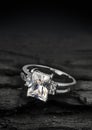 Jewelry ring witht big diamond on dark coal background Royalty Free Stock Photo