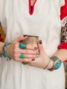 Ceramic clay pot in female hands. Jewelry, gems. Pottery and hands