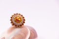 Jewels gift concept. Close-up of cocktail golden ring on seashell on white background