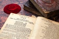 Jewish Bible. A stack of old leather-bound Jewish books with gold stamping and red knitted jewish bale. One book is open