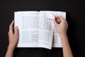 Jewish book, with woman`s hand, on black background. Text of the Hebrew, prayer. Woman reading book. Royalty Free Stock Photo