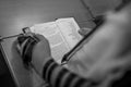 Jewish boy with Tefillin on his hand reading Torah at Bar Mitzvah