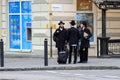 3 Jewish boys, Hasidic Jews, in black clothes and hats with suitcases and luggage stand on the street. Religious Orthodox Jew