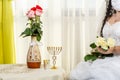 A Jewish bride, a fragment of her face before a chuppa ceremony during a pandemic, wearing a medical mask and a bouquet Royalty Free Stock Photo