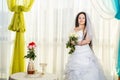 A Jewish bride in a synagogue before a chuppa ceremony during a pandemic, wearing a medical mask and a bouquet of Royalty Free Stock Photo
