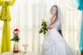 A Jewish bride in a synagogue with a veil covered before a chuppa ceremony during a pandemic, wearing a medical mask and a bouquet Royalty Free Stock Photo