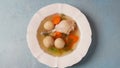 Jewish chicken broth with kneidlach (balls made with matzo meal). Matzo ball soup