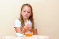 Jewish child dipping apple slices into honey on Rosh HaShanah.