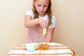 Jewish child dipping apple slices into honey on Rosh HaShanah.