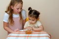 Jewish children dipping apple slices into honey on Rosh HaShanah. Royalty Free Stock Photo