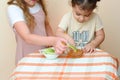 Jewish children dipping apple slices into honey on Rosh HaShanah. Royalty Free Stock Photo