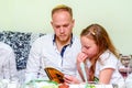 Jewish family celebrate Passover Seder reading the Haggadah.