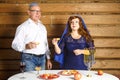 A Jewish family, a husband in a kippah and a wife in a cape on their heads in Rosh Ashana eat challah in honey at a Royalty Free Stock Photo