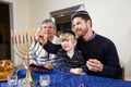 Jewish family lighting Chanukah menorah Royalty Free Stock Photo