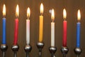 Jewish Festival of Lights Hanukkah holiday menorah candles in red blue yellow and white Royalty Free Stock Photo