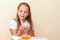 Jewish girl dipping apple slices into honey on Rosh HaShanah. Royalty Free Stock Photo