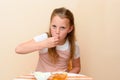 Jewish girl dipping apple slices into honey on Rosh HaShanah. Royalty Free Stock Photo