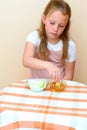 Jewish girl dipping apple slices into honey on Rosh HaShanah. Royalty Free Stock Photo