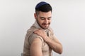 Jewish Guy Showing Vaccinated Arm After Antiviral Injection, Studio Wall Royalty Free Stock Photo