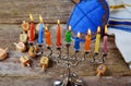 Jewish holiday hannukah symbols - menorah, doughnuts, chockolate coins and wooden dreidels.