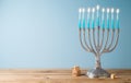 Jewish holiday Hanukkah background with menorah and candles on wooden table Royalty Free Stock Photo