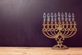 Jewish holiday Hanukkah background with menorah over chalkboard with hand drawing Royalty Free Stock Photo