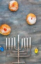 Jewish holiday Hanukkah background. A traditional dish is sweet donuts. Hanukkah table setting a candlestick with candles and