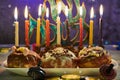 Jewish holiday Hanukkah background. A traditional dish is sweet donuts. Hanukkah table setting a candlestick with candles and