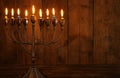 jewish holiday Hanukkah background with traditional spinnig top, menorah & x28;traditional candelabra& x29; and burning candles.