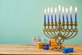 Jewish holiday Hanukkah background with vintage menorah and gift boxes